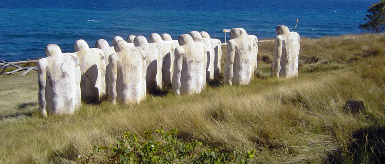 Photo of memorial of figures looking over the sea in Le Diamant