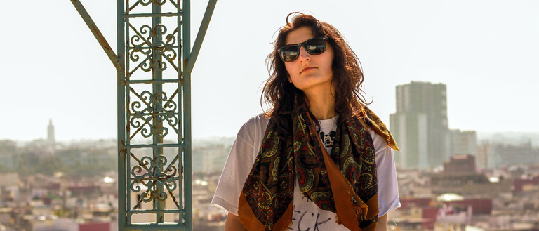 Student stands on a balcony in Jordan
