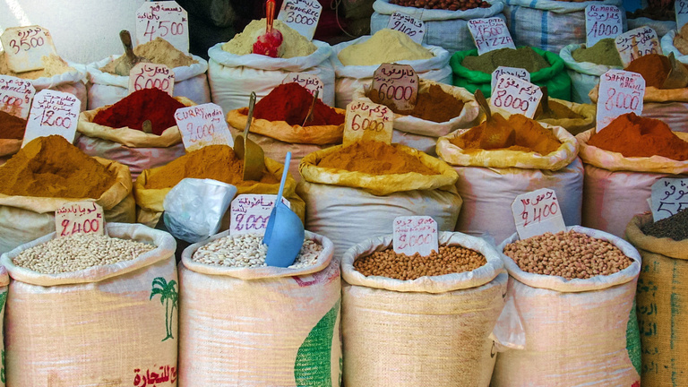 Bags of spices and other food at an outdoor market