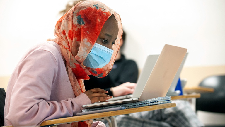 Student works on a laptop in class