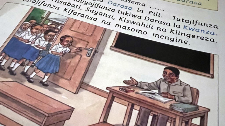 Swahili written above a drawing of a class taking place as printed in a book