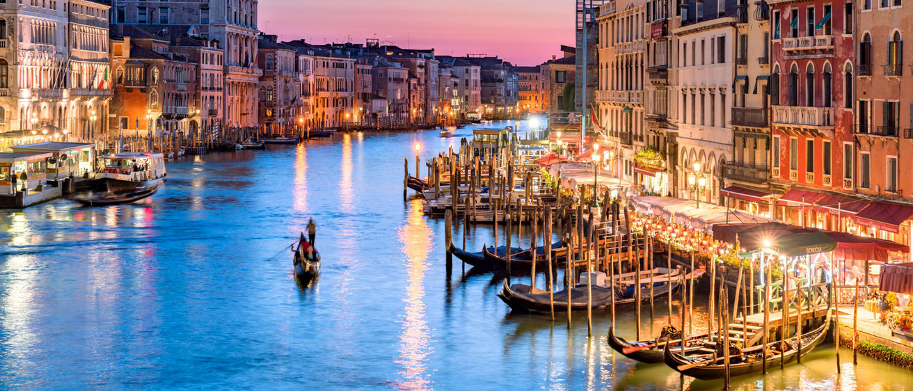 Gondola moving through the canals of Venice at sunset