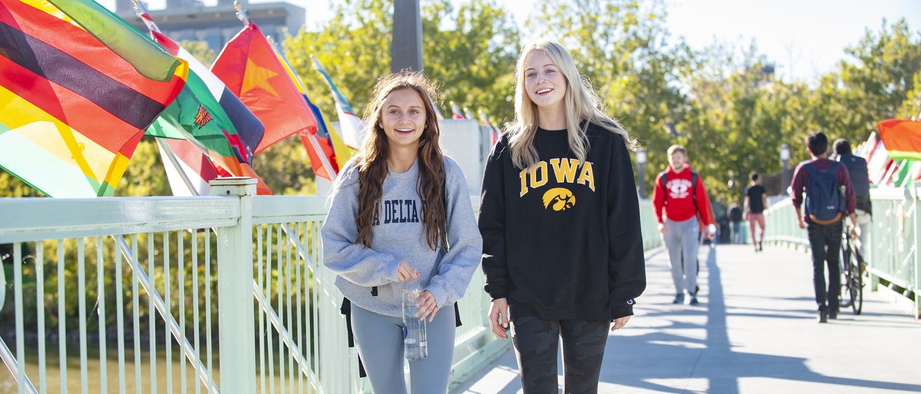 International Flags students walking across bridge