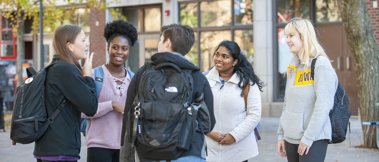 Students speaking in ASL in a group outdoors
