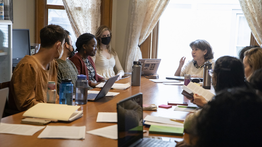 Professor discussing with table of students