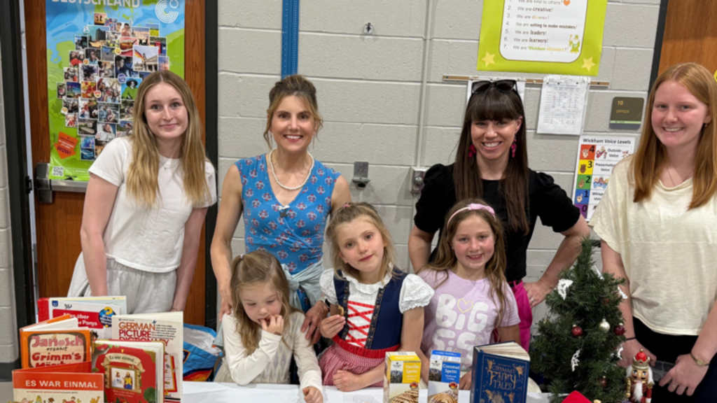 UI professors Kirsten Kumpf Baele and Kay Ramey stand at the German table during the event